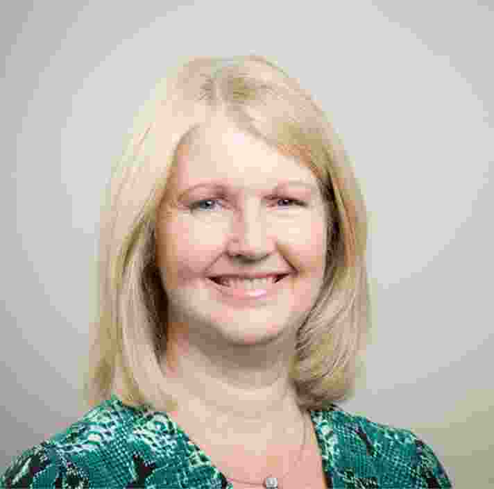 Head shot of Guide Dogs South Australia's Chief People and Culture Officer, Katherine Stocco. Katherine is looking at the camera smiling.