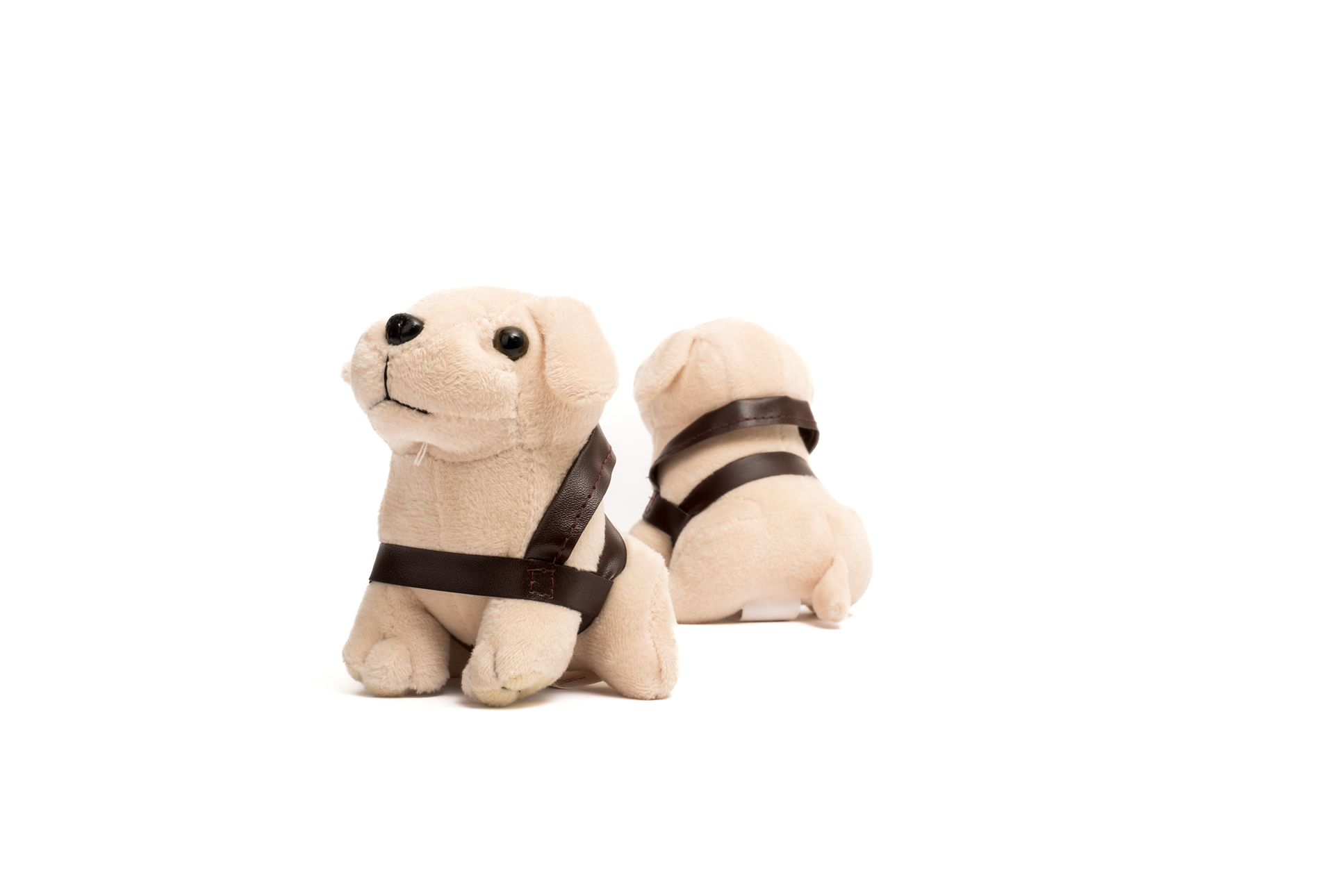 Two Mini Plush Dog toys wearing brown harnesses are positioned on a white background, facing opposite directions.