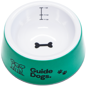 Green pet bowl with Guide Dogs text and a black bone design inside. Measurement markings for 1/4 cup, 1/2 cup, and 1 cup.