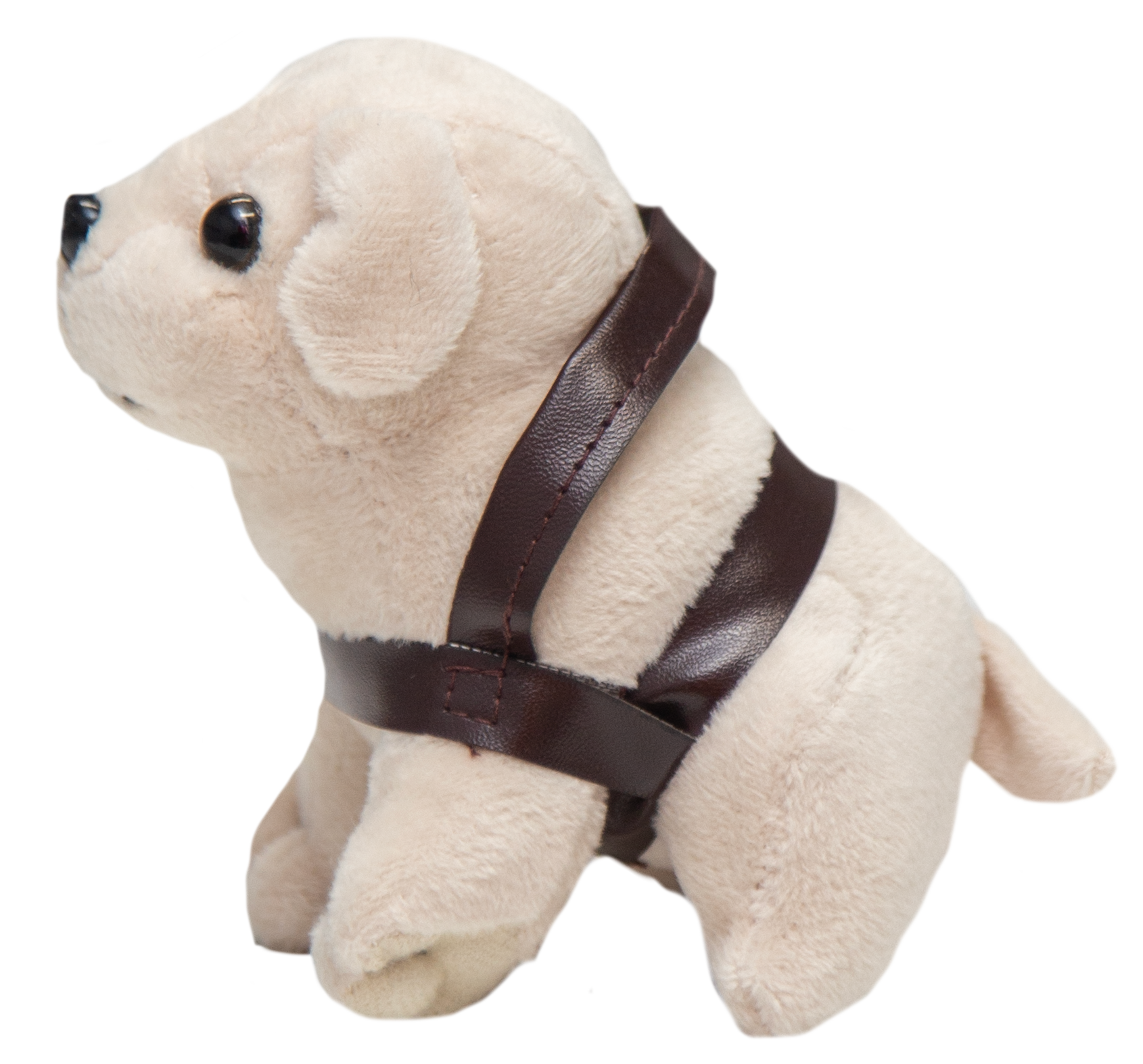 The Mini Plush Dog, wearing a brown harness, is sitting on a white surface.