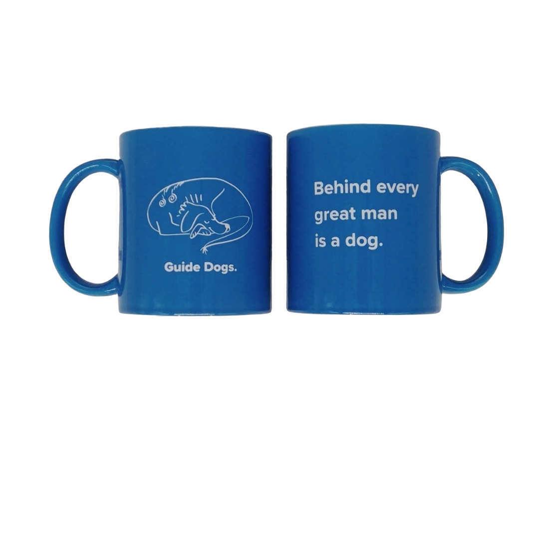 Product Data: A pair of blue ceramic mugs with white text. One mug features the words "Guide Dogs" accompanied by an illustration of a dog and person, while the other mug displays the phrase "Behind every great man is a dog.