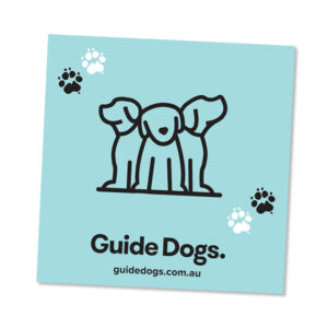 The glasses pouch features a logo with three outlined dogs and four paw prints set against a blue background. The text reads "Guide Dogs" along with the URL: guidedogs.com.au.