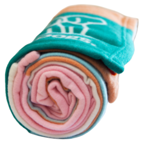 A rolled-up Polar Fleece Rug in multiple colors, displaying pink, blue, orange, and green layers.