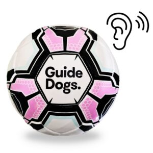 The Audible Soccer Ball features a hexagonal pattern with Guide Dogs text beside an ear icon and sound waves, signifying an auditory function.