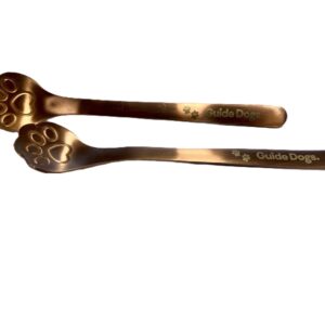 Two metallic Paw Print spoons, each with handles decorated with paw prints and the words Guide Dogs printed on them.