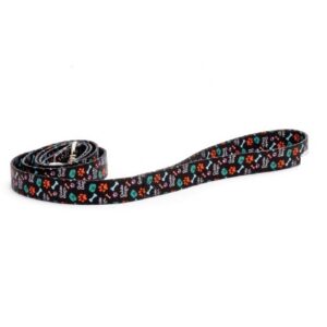 A Dog Lead - Black with vibrant skull and bone patterns lies coiled on a white background.