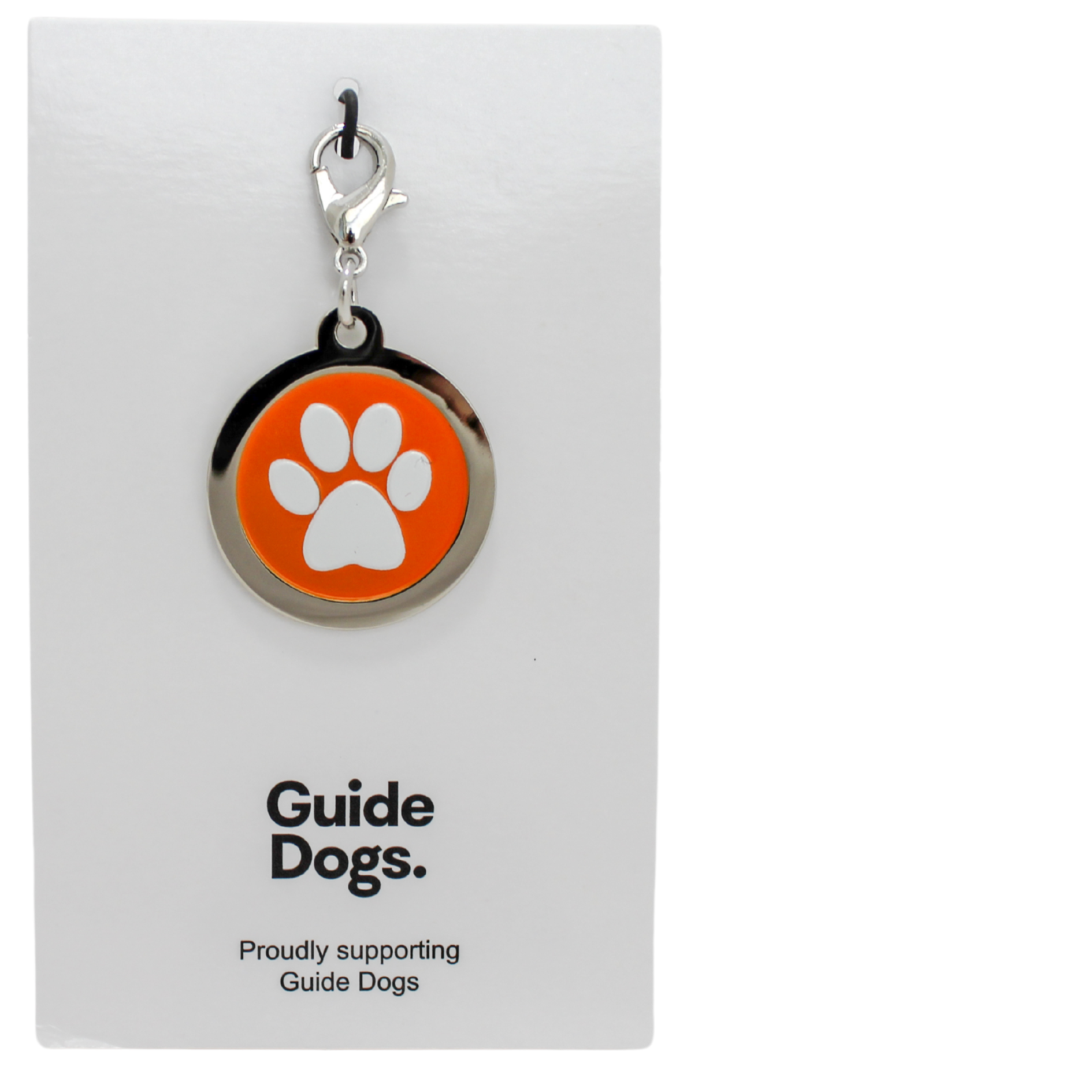 A Paw Print Charm keychain with an orange emblem is displayed on a card that reads Guide Dogs. Proudly supporting Guide Dogs.
