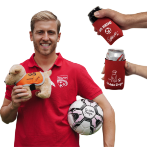 A man in a red shirt holds a black plush from the Family Bundle - Adelaide United Football Club set, which includes 2 black plush toys and 2 can coolers.