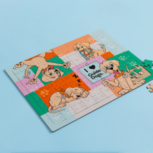 A partially completed Jigsaw Puzzle with cartoon puppies and I ♥ Guide Dogs text on a light blue background. Four pieces are beside the puzzle.