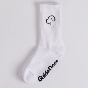 The Crew Socks - White feature a minimalist black outline of a dogs head near the top and Guide Dogs printed on the sole.