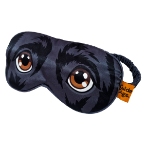 Eye Mask featuring a printed design of large cartoon dog eyes and an orange tag labeled "Guide Dogs.